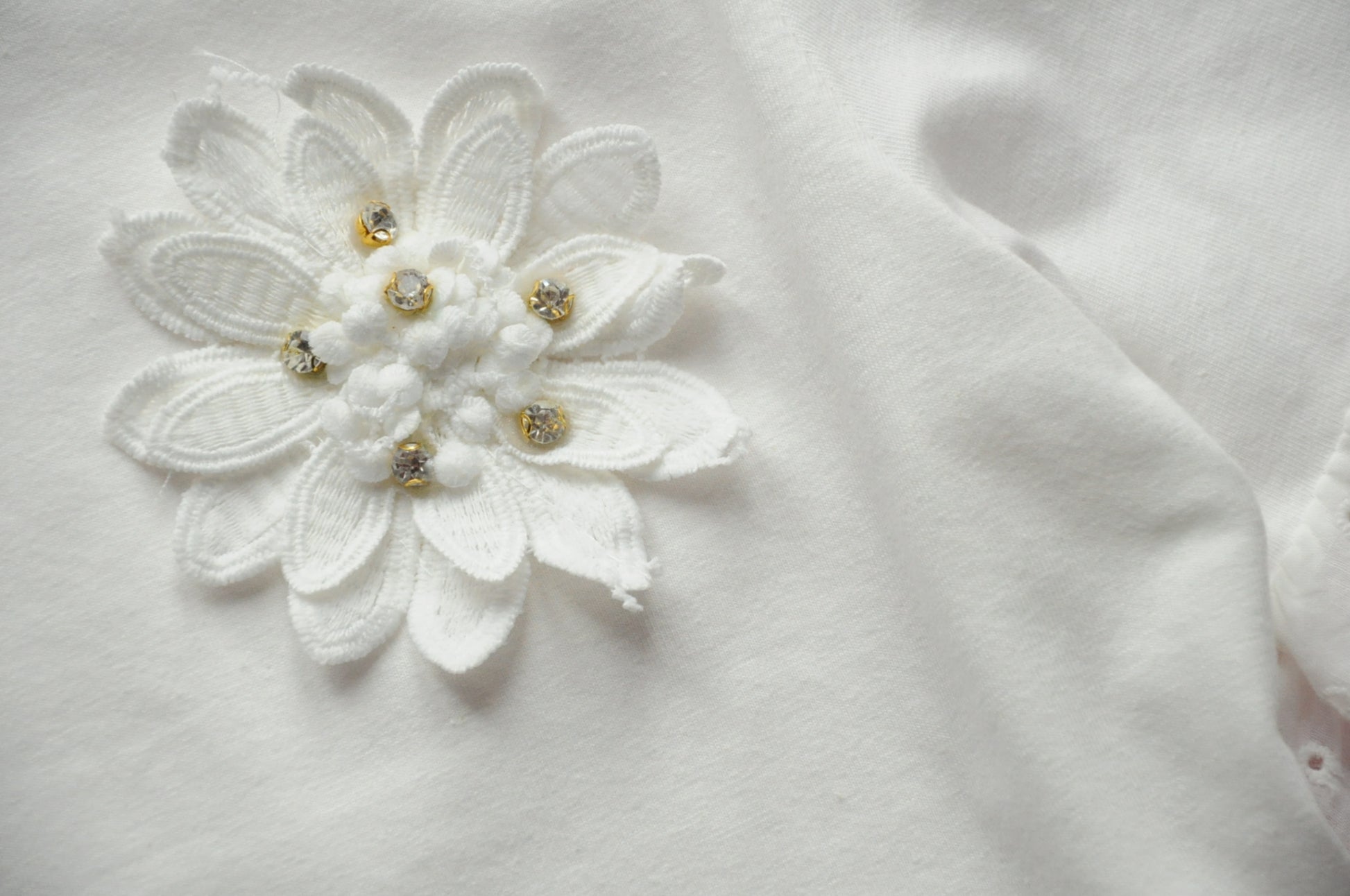 Off white broderie anglaise frilled peplum tee with 3D gem flower detail